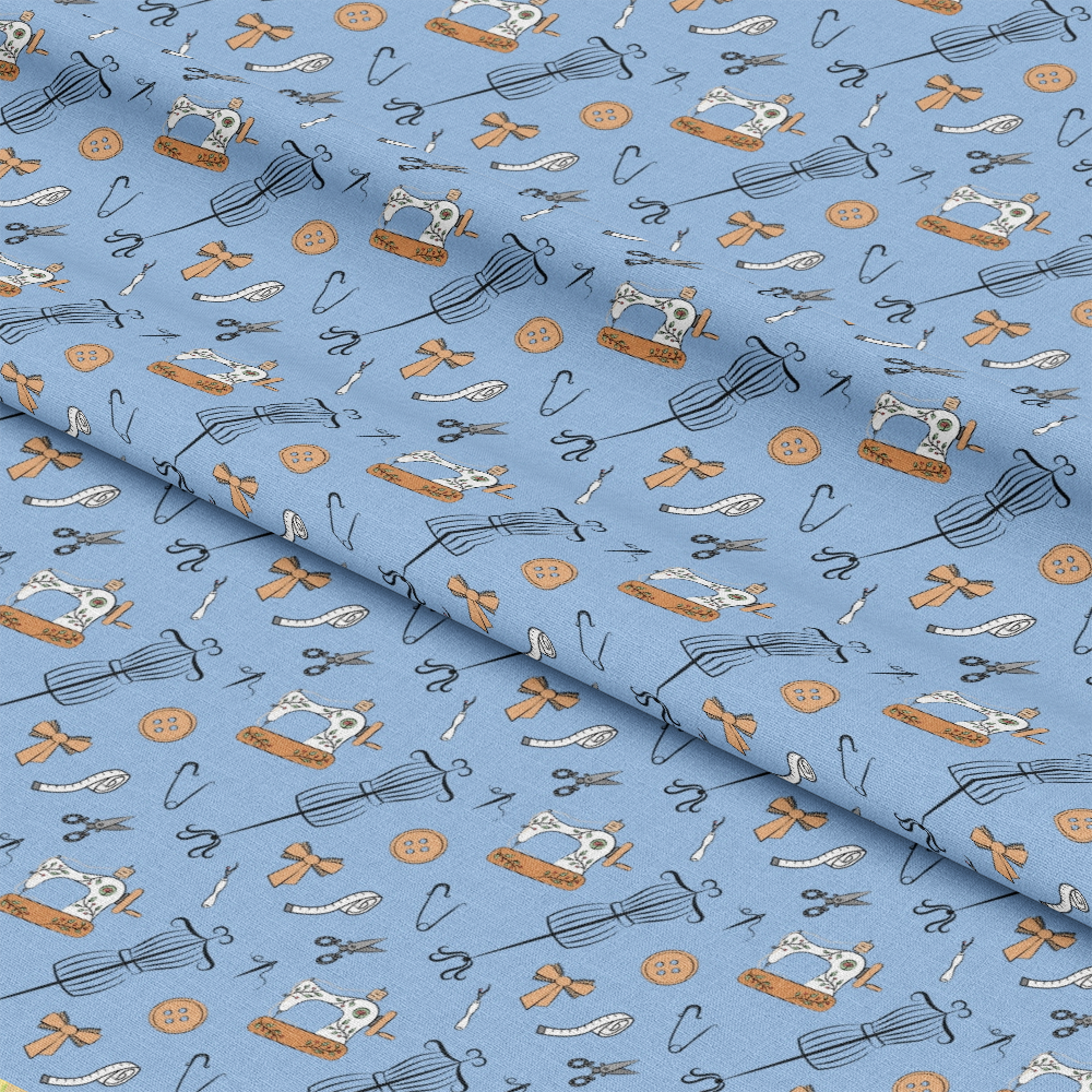 Assorted Sewing Pattern 3 Quilting Cotton Fabric featuring blue background, vintage sewing machines, dress forms, buttons, scissors, safety pins, ribbons, thread spools, cotton material, quilting fabric, craft textile, light blue, beige, black, detailed sewing motifs, traditional quilting cotton textile