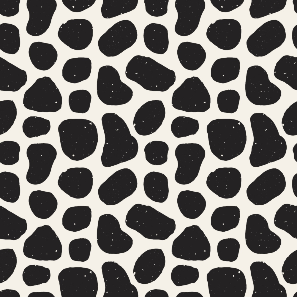 Pattern of irregular black spots on a white background, resembling animal print.