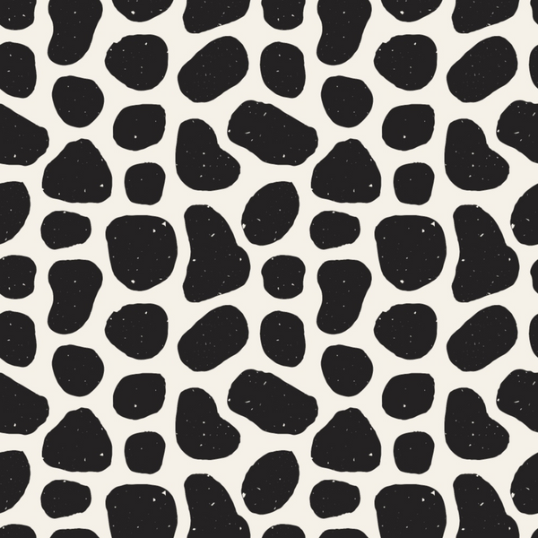 Pattern of irregular black spots on a white background, resembling animal print.
