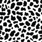 Black and white cow print pattern with irregular spots scattered across the image.