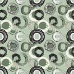 Abstract pattern with overlapping circles in black, white, and green on a light green background.