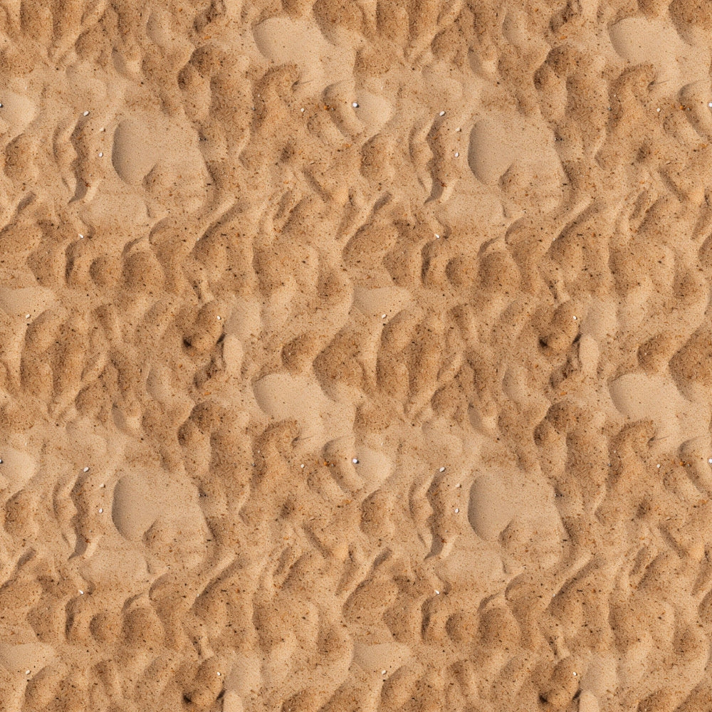Close-up view of textured sand with ripples and small impressions, creating a wavy pattern across the surface.