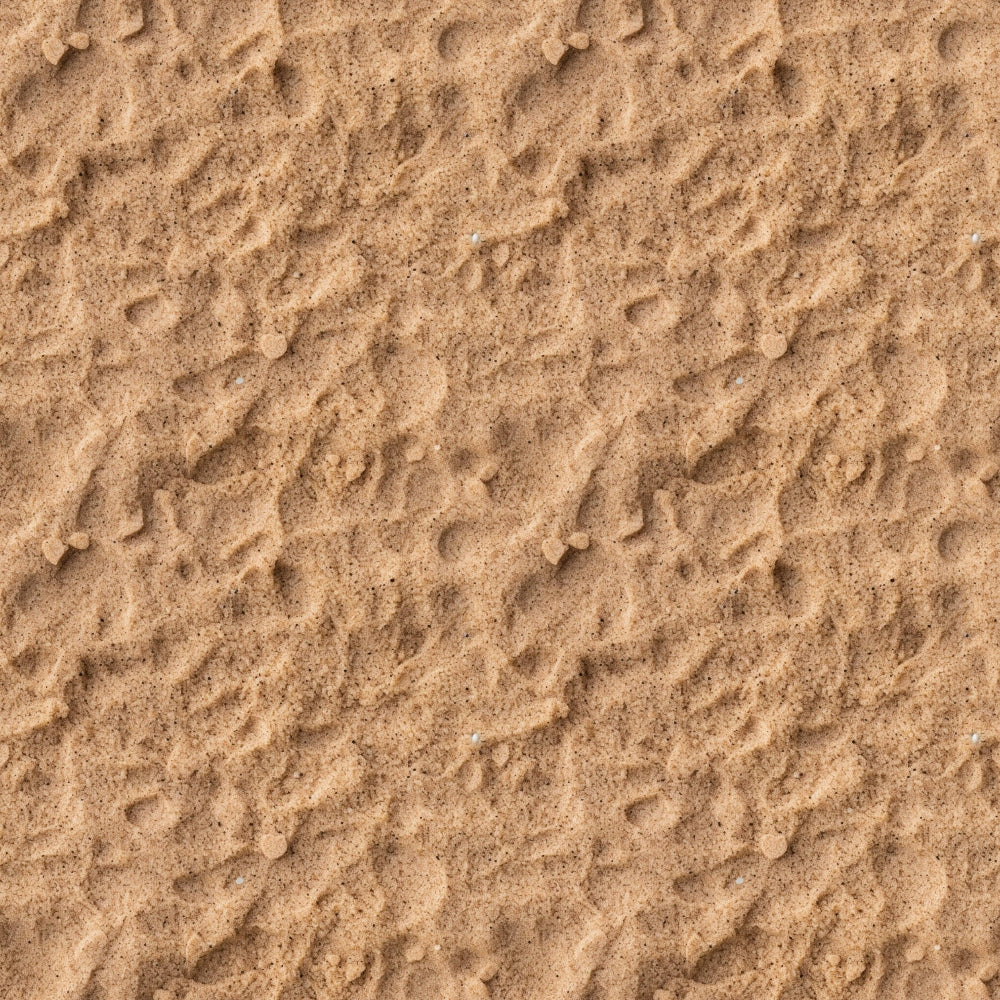 A close-up view of textured sand with small ripples and scattered pebbles.