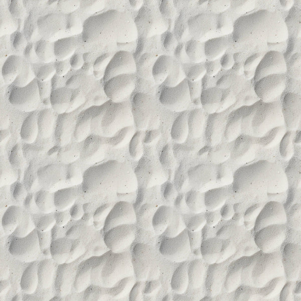 Close-up of white sand with rippled patterns and shadows.