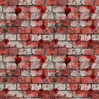 Patterned wall with red and gray bricks, featuring red paint splatters and drips, creating an abstract urban look.