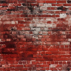 Weathered red brick wall with black and white stains.