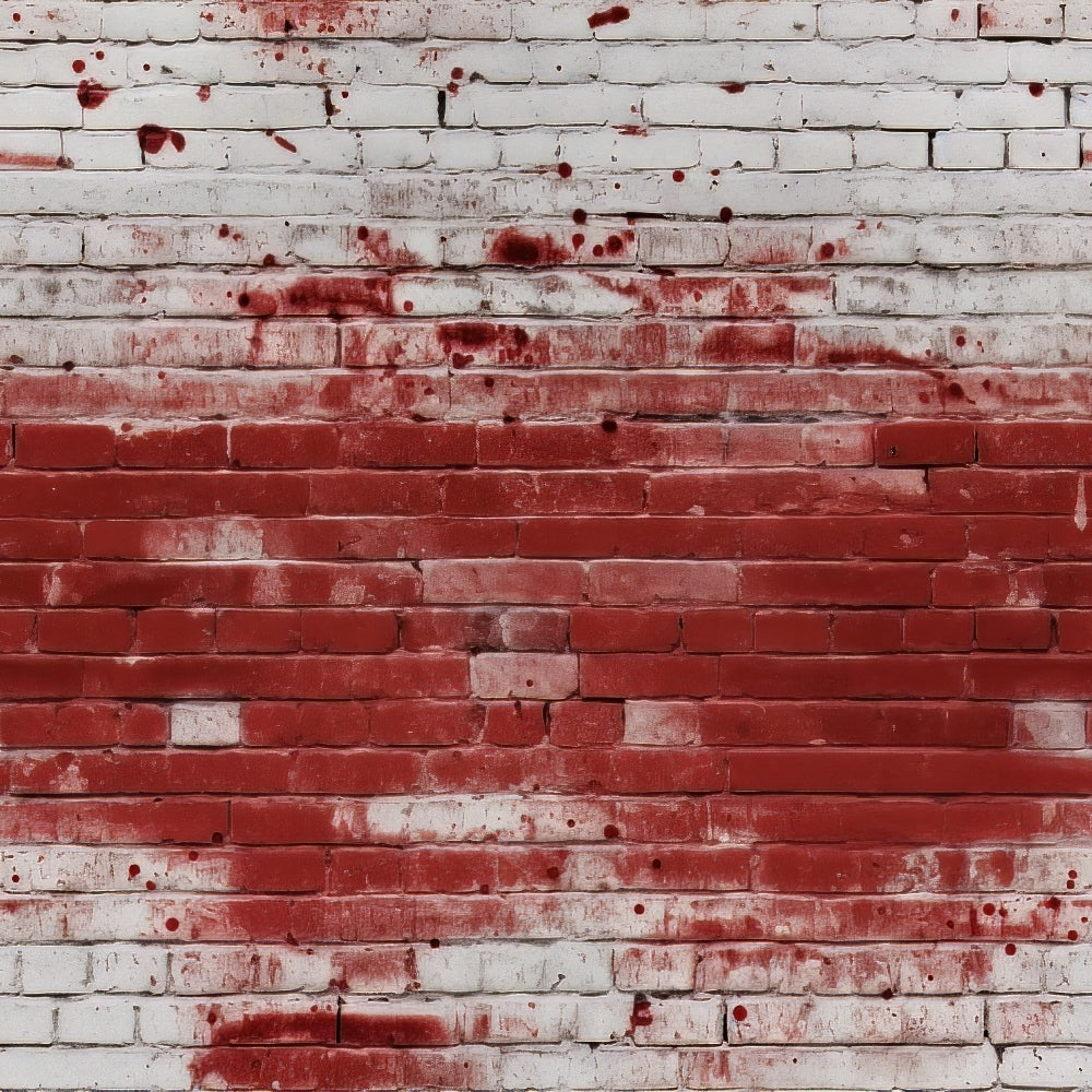 White brick wall with red paint splatters across the surface.