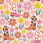 Pattern of cow-print cowboy boots, yellow and pink flowers, green leaves, and sheriff badges on a pink background.