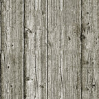 Wooden planks aligned vertically, showing a weathered texture with visible knots and grain patterns. The color is a muted grayish-brown, suggesting age and exposure to elements.