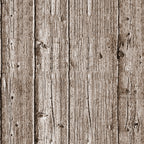 Close-up view of a wooden plank wall with vertical panels, displaying a textured surface with visible grain patterns and knots. The wood appears aged and weathered.