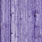 Close-up of a wooden fence with vertical planks painted purple, showing wood grain and knots.