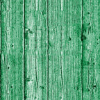 Close-up of a green wooden wall with vertical planks showing natural wood grain and knots.