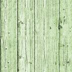 A green wooden plank surface with visible grain and knots.